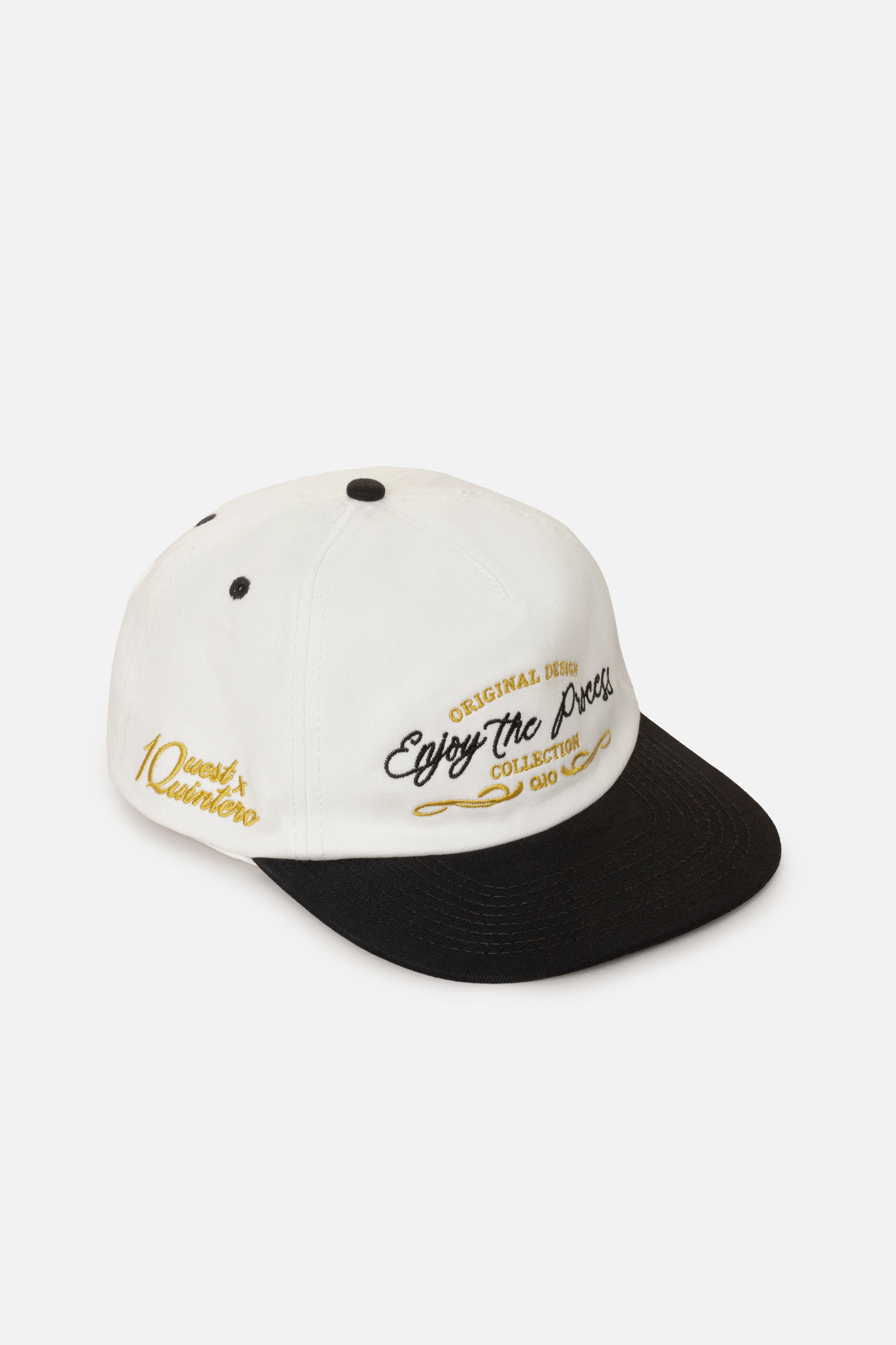 GORRA BEISBOLERA EN BLOQUES DE COLOR BEIGE CON BORDADO MARCA QUEST X JUAN FERNANDO QUINTERO